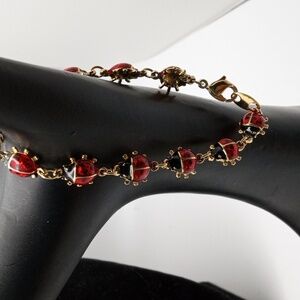 Ladybug gold toned link bracelet.